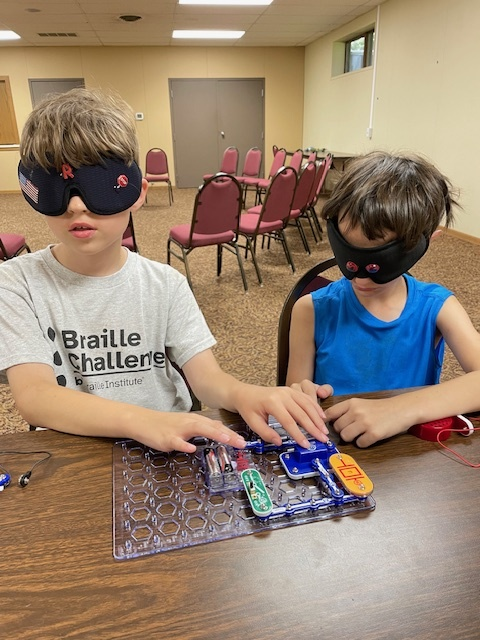 campers in  braille class exploring circuit boards