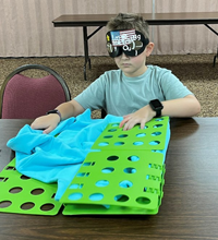 2024 camper learning to fold a shirt